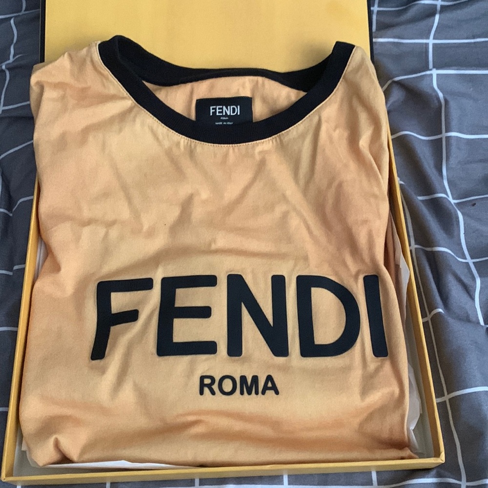 I’m selling a short sleeve Fendi shirt. It’s mustard yellow and a size small.
